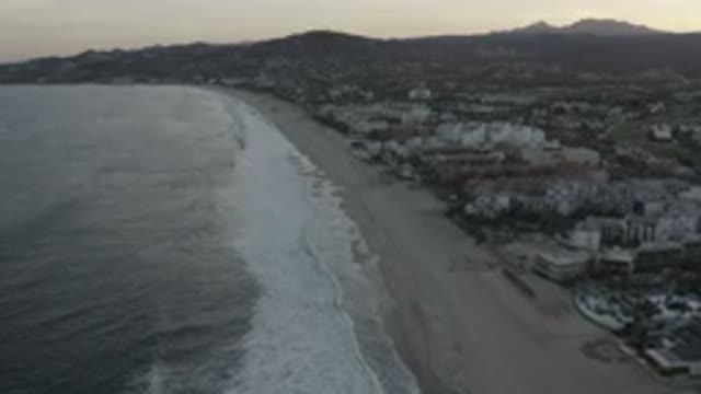 LOS CABOS MEXICO-2020: A Beautiful View Of The Ocean And Beach With Mountains In