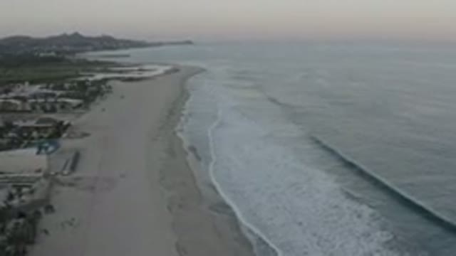 LOS CABOS MEXICO-2020: Glistening Beach Waves Arriving On The Shore