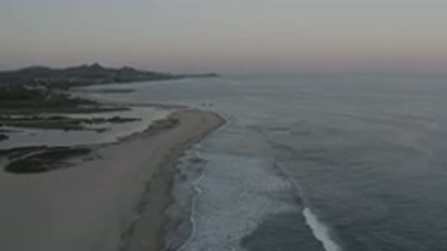 LOS CABOS MEXICO-2020: A Side View Of A Beach With Gentle Waves On It