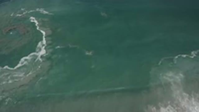 SAN JOSE DEL CABO MEXICO-2020: Calm Green Ocean Waves Breaking With A Whirlpool