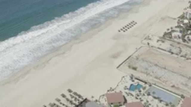 SAN JOSE DEL CABO MEXICO-2020: Aerial View Of A Beach With Sea Foam And Some Houses