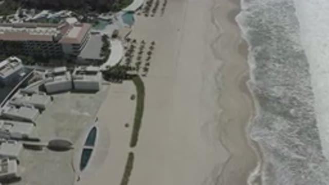 SAN JOSE DEL CABO MEXICO-2020: An Aerial View Of A Beach With Surf Coming Ashore