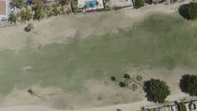 SAN JOSE DEL CABO MEXICO-2020: Video Footage Of An Open Grassy Area With Nearby Homes And Trees