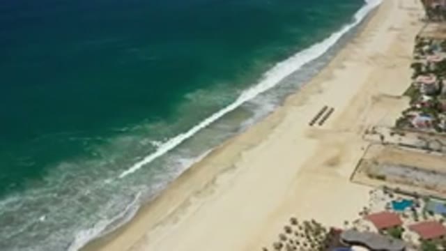 SAN JOSE DEL CABO MEXICO-2020: A Beach With Dark Blue Water Sea And Calm Waves