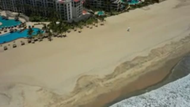 SAN JOSE DEL CABO MEXICO-2020: A Beach Surrounded By Nice Hotels And Condos And