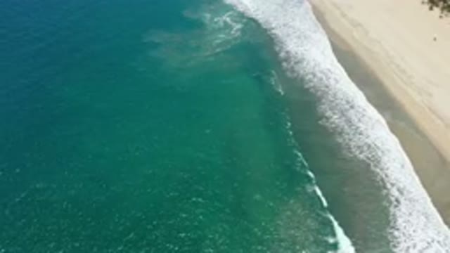 SAN JOSE DEL CABO MEXICO-2020: Small Waves From A Calm Sea Breaking Slowly