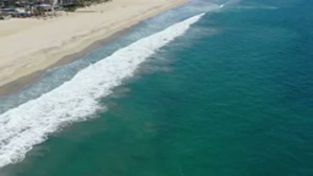 SAN JOSE DEL CABO MEXICO-2020: Top View Of Green Sea With Rough Waves Dragging