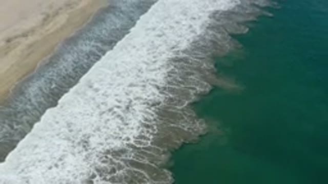 SAN JOSE DEL CABO MEXICO-2020: Drone Shot Of Waves Slowly Breaking On A Sandy Beach