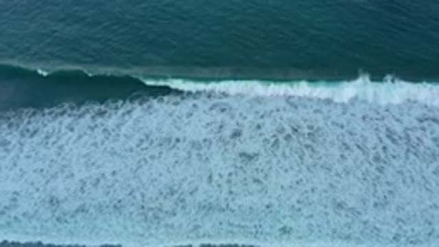 SAN JOSE DEL CABO MEXICO-2020: Deep Blue Wave Breaking With A Curl On A Sandy Beach