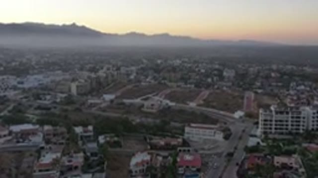 SAN JOSE DEL CABO MEXICO-2020: Aerial View Of A Town In A Hilly Region At Sunset