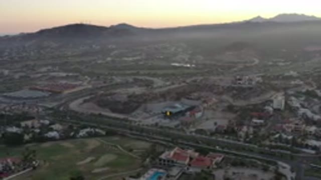 SAN JOSE DEL CABO MEXICO-2020: A Beautiful Mountain With A Red Orange Sunset And Homes