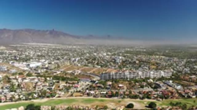 LOS CABOS MEXICO-2020: Topside View Of A Large Group Of Buildings In A City And Mountains