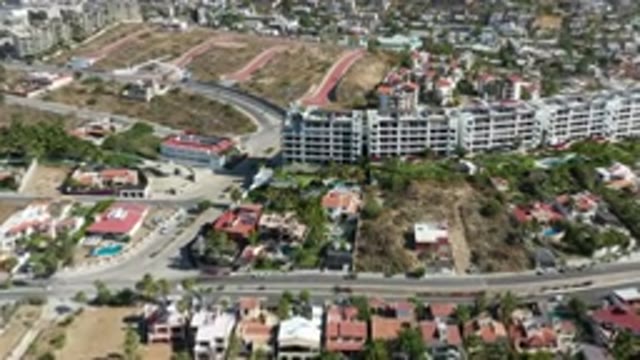 LOS CABOS MEXICO-2020: Moving Aerial View Over City With Large Apartment Buildings