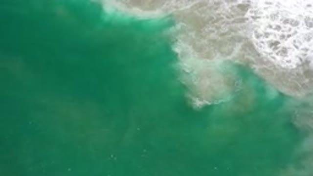 LOS CABOS MEXICO-2020: A Green Deep Sea Water With Sandy White Bubble Wave On It