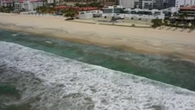 LOS CABOS MEXICO-2020: Top View Of Green Sea With Calm Waves And Building In