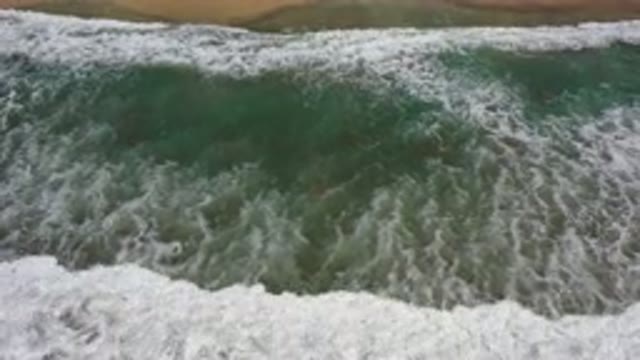 LOS CABOS MEXICO-2020: Sea Water Breaking On A Wet Dark Sand Beach