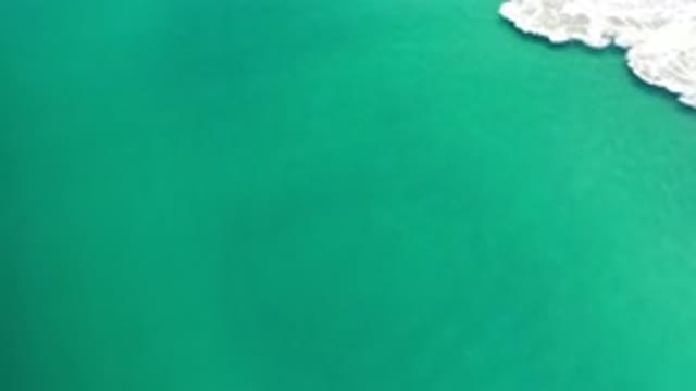 LOS CABOS MEXICO-2020: Very Slow Calm Waves In Light Blue Sea During A Bright