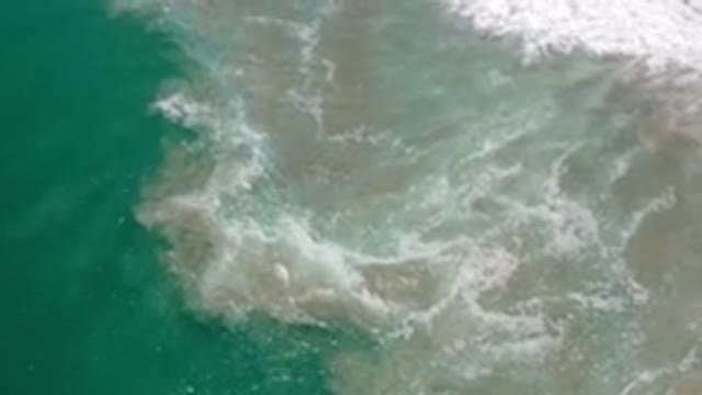 LOS CABOS MEXICO-2020: Blue Green Sea Waves Crashing Against Sandy Shore With