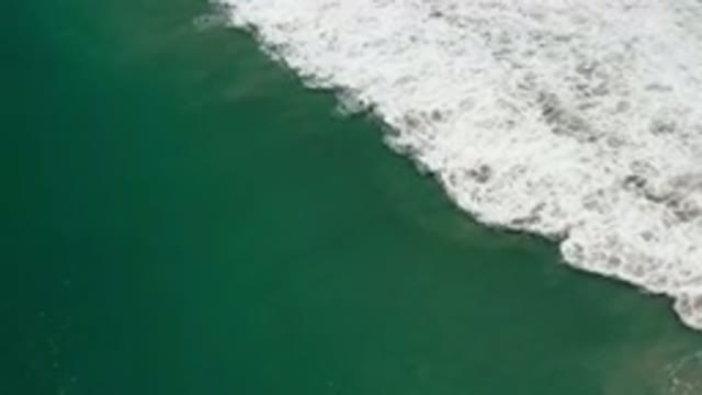 LOS CABOS MEXICO-2020: Green Ocean Waves Crashing with White Foam