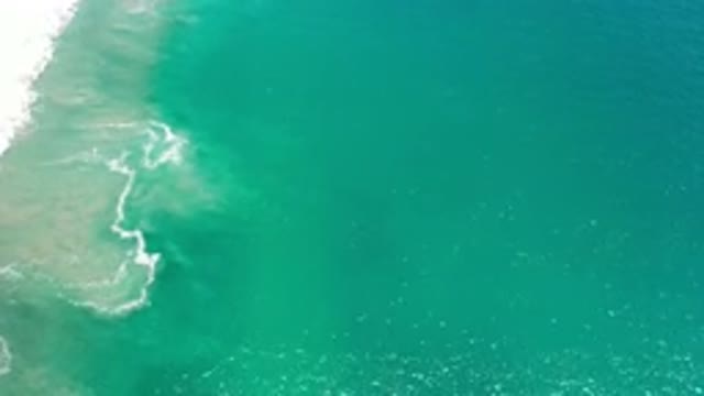 LOS CABOS MEXICO-2020: Brilliant Blue Green Water Washes Against A Shore That