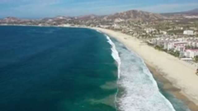 LOS CABOS MEXICO-2020: A Top View Of Deep Blue Sea And Waves On A Sandy Beach