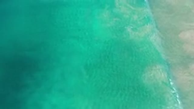 LOS CABOS MEXICO-2020: Beautiful Aerial View Of Green Sea Waves Touching The Shore
