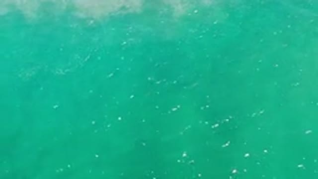 LOS CABOS MEXICO-2020: A Top View Of Deep Green Sea Water With Light Waves And Fog