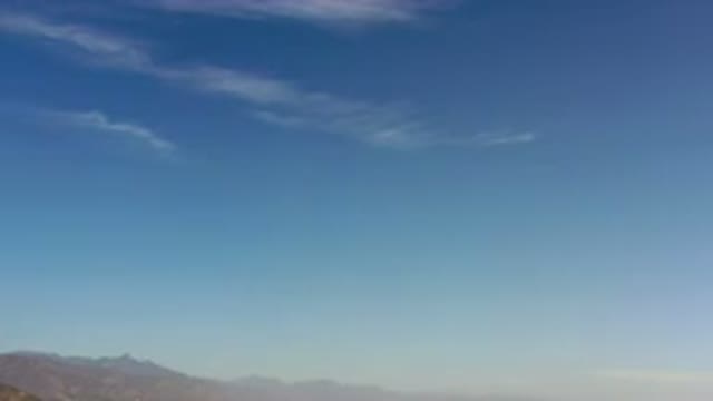 LOS CABOS MEXICO-2020: Camera Panning Down From Sky Over Mountain Landscape And