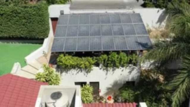 LOS CABOS MEXICO-2020: Green House With Black Roof and Lush Trees