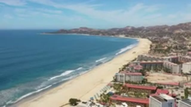 LOS CABOS MEXICO-2020: Beachside Buildings and Trees Between Sand and Sky