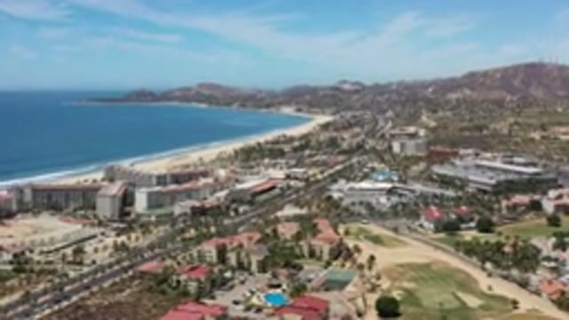 LOS CABOS MEXICO-2020: A Town With Buildings And A Beach With Mountains