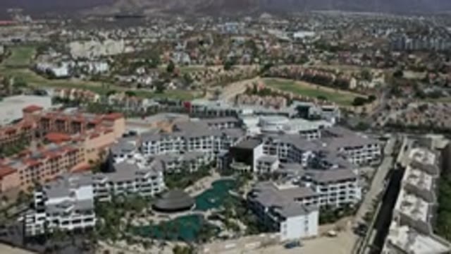 LOS CABOS MEXICO-2020: Flying Above Large Resort With Gray Buildings And Pools