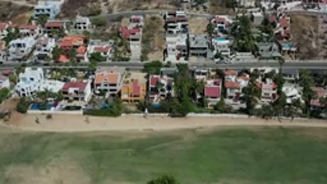 LOS CABOS MEXICO-2020: Aerial View Of A Beach Town With Colorful Homes From A Plane