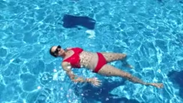 LOS CABOS MEXICO-2020: Young Woman in Red Bikini Taking a Bath at a Swimming Pool