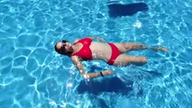 LOS CABOS MEXICO-2020: Woman In Red Bikini And Sunglasses Floating And Swimming