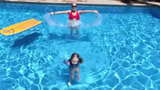LOS CABOS MEXICO-2020: Woman In Red Bathing Suit And Child Enjoy Swimming In A
