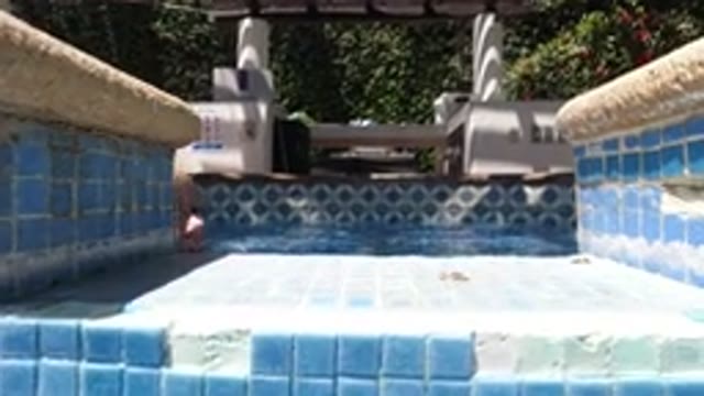 LOS CABOS MEXICO-2020: A Kid Is Playing In A Pool While Smiling To The Camera