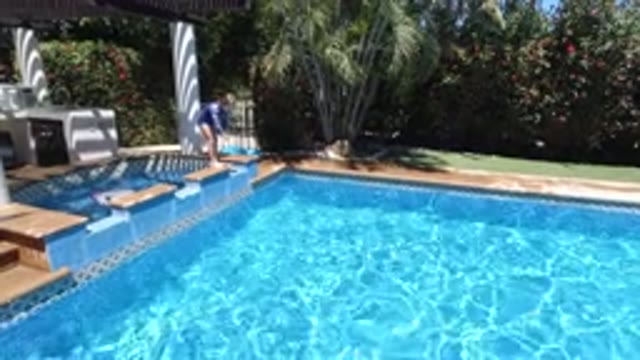 LOS CABOS MEXICO-2020: A Kid Attempting To Dive Into The Pool From The Ledge