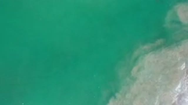 LOS CABOS MEXICO-2020: Top View Of Deep Green Water And Moving Sand Underneath
