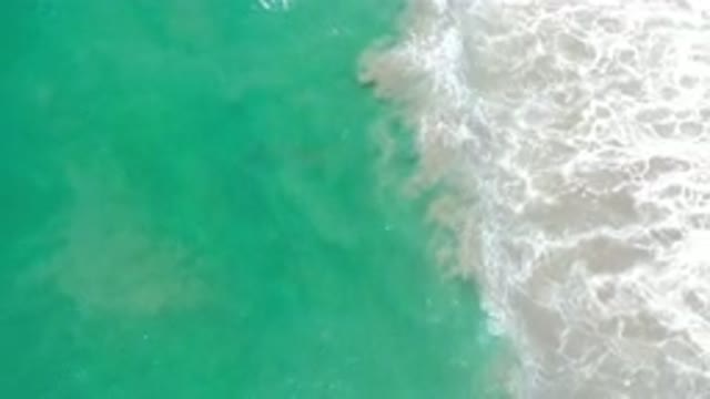 LOS CABOS MEXICO-2020: Bluish Green Water Gliding Peacefully Onto The Shore Bath