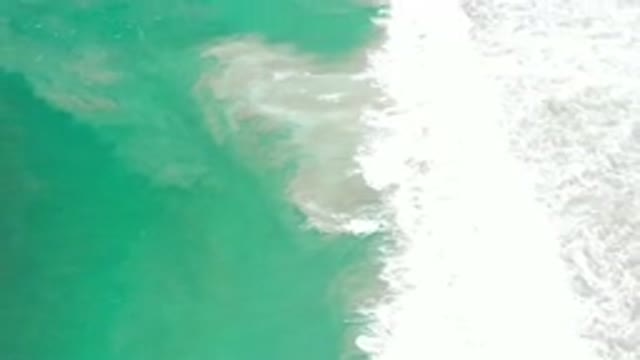 LOS CABOS MEXICO-2020: Deeply Shining Green Water Sea With Waves Crashing At The Beach
