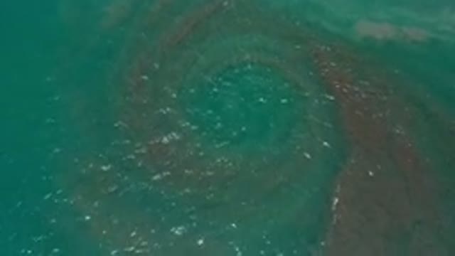 LOS CABOS MEXICO-2020: Zoom In On Water And Sand Swirling In The Ocean Making