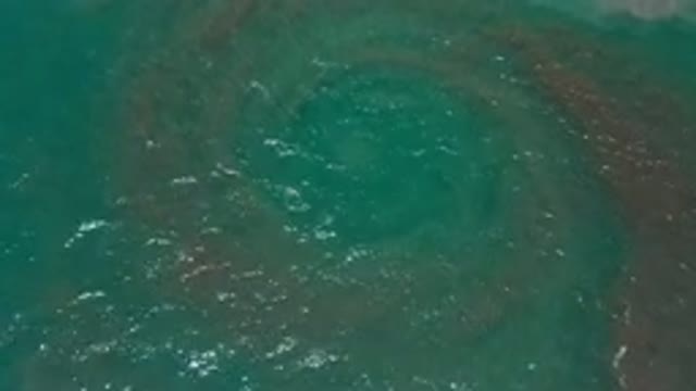 LOS CABOS MEXICO-2020: Clear Ocean With A Pink Eddy Spreading Out In The
