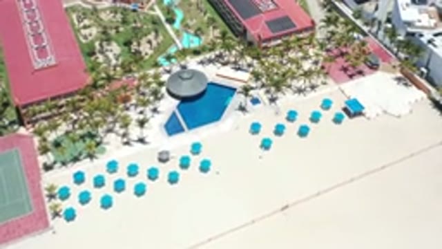 LOS CABOS MEXICO-2020: A Wide Beach And Buildings Of Hotels Or Resorts With Big