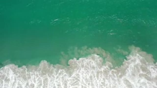 LOS CABOS MEXICO-2020: A Top View Of Green Deep Water And White Loose Sand Waves