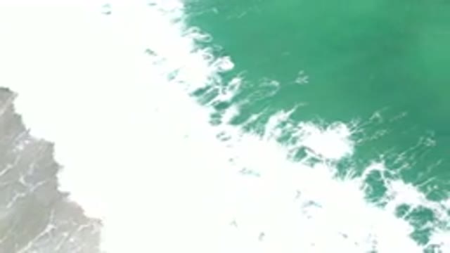 LOS CABOS MEXICO-2020: Aerial View Of Green Water Splashing On The Shore