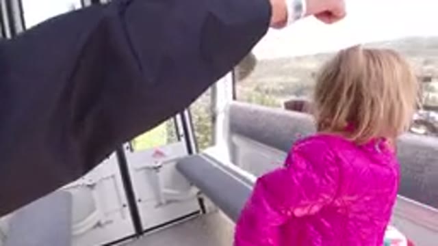 WINTER PARK COLORADO-2019: Happy Little Girl Sees Outside the Ski Lift Ride