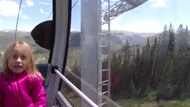 WINTER PARK COLORADO-2019: Ropeway Ride With Little Girl Amid Trees And Greenery