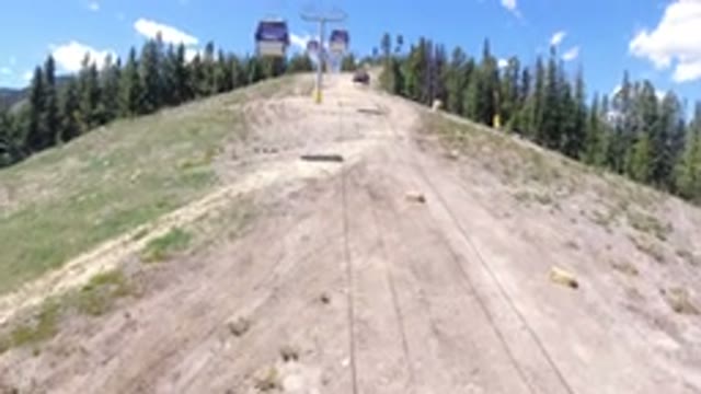 WINTER PARK COLORADO-2019: Riding A Lift Up A Mountain Side With Pine Trees And