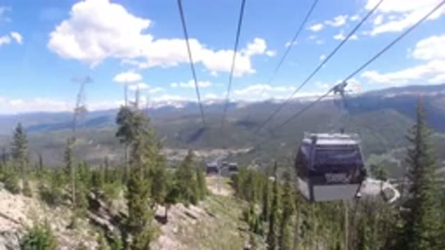 WINTER PARK COLORADO-2019: Riding On A Suspended Cable Lift On A Wooded Mountainside